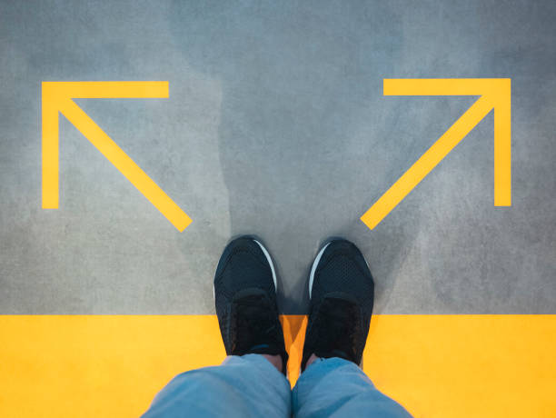 istock Man Standing with Arrow Direction Choice Left and Right 1628885655