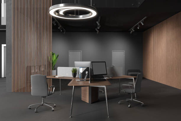 istock Dark business interior with pc computer on office desk, relax zone and door 1628894549