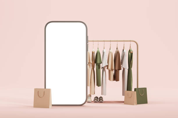 istock Clothes hanging on a rail, large mock up smartphone screen on beige background 1628903834