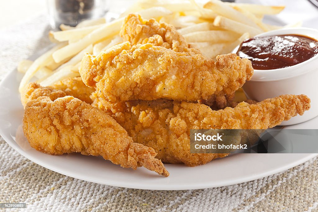 Organic Crispy Chicken Strips Organic Crispy Chicken Strips on a background Chicken Meat Stock Photo