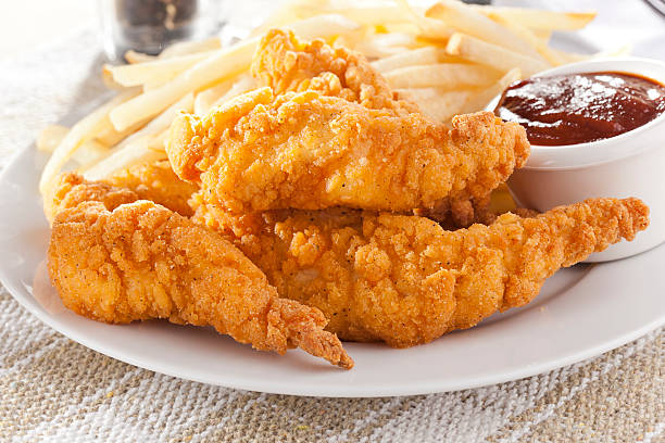 Organic Crispy Chicken Strips Organic Crispy Chicken Strips on a background chicken meat photos stock pictures, royalty-free photos & images