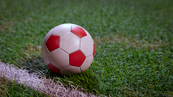 Football (Soccer) on field grass close-up background, 3d rendering