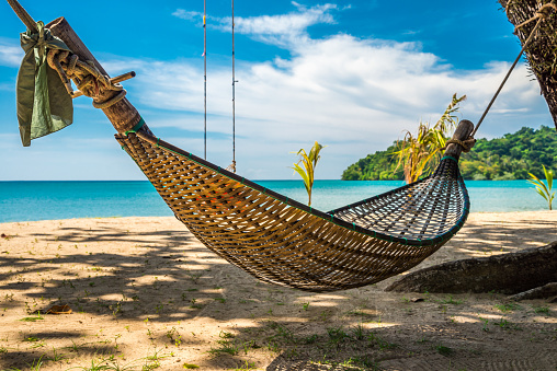Wooden daybed swing on beautiful tropical island beach Ko Mak, Trat Thailand. Travel summer beach holiday, nature concept.