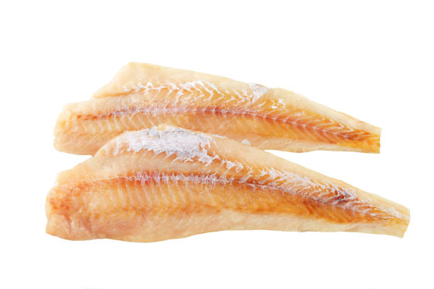 2 fresh fish fillet sat on top of each other Fresh fish fillets isolated on white haddock stock pictures, royalty-free photos & images