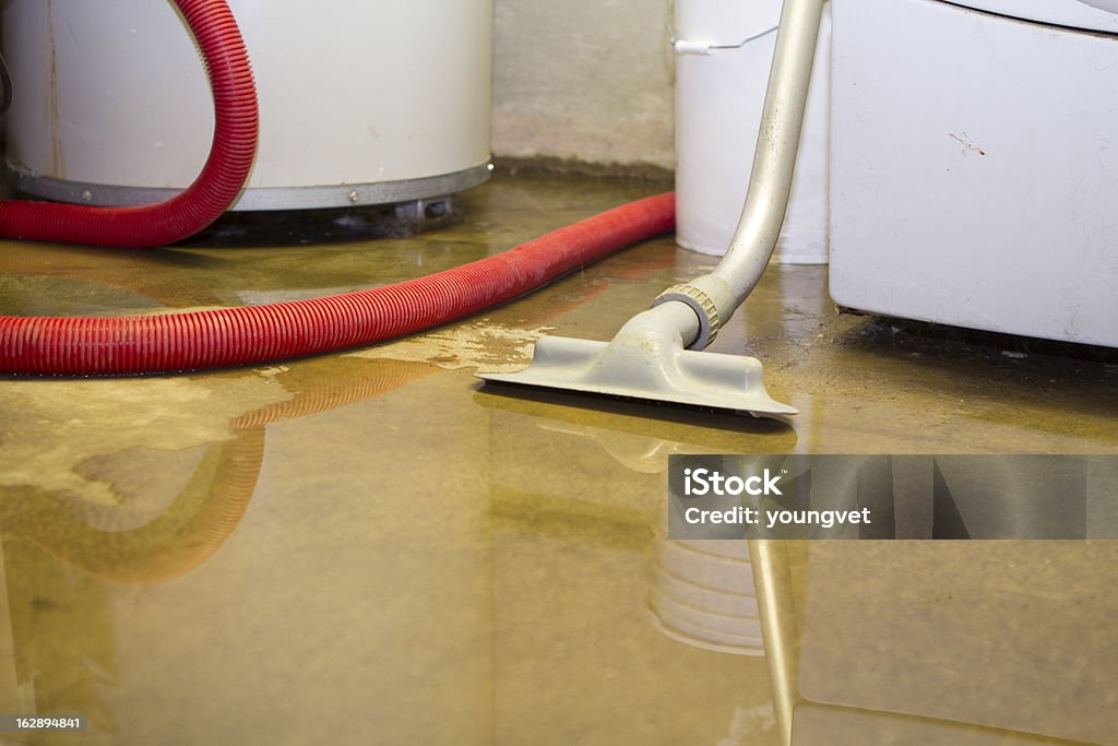 Flooded basement cleanup Cleaning up a blooded basement. Narrow depth of field. Flood Stock Photo