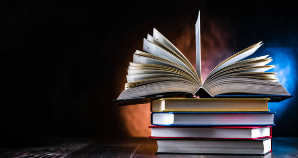 istock A composition with an open book lying on a stack of other books 1628955275