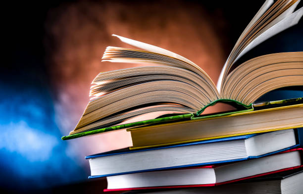 istock A composition with an open book lying on a stack of other books 1628955839