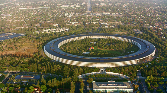 Cupertino, California / USA - December 22, 2022: Aerial view of Apple corporate headquarters building in Silicon Valley.\n\nApple Inc. is an American multinational technology company headquartered in Cupertino, California that designs, develops, and sells consumer electronics, computer software, and online services.