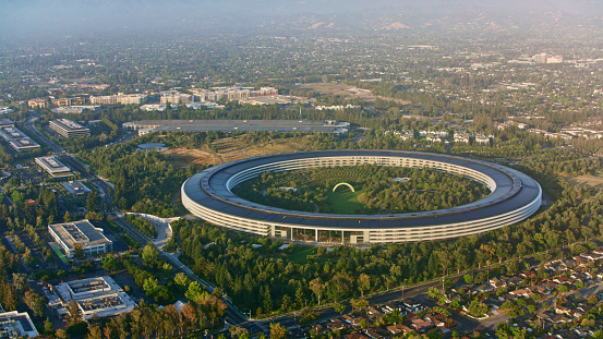 Cupertino, California / USA - December 22, 2022: Aerial view of Apple corporate headquarters building in Silicon Valley.\n\nApple Inc. is an American multinational technology company headquartered in Cupertino, California that designs, develops, and sells consumer electronics, computer software, and online services.