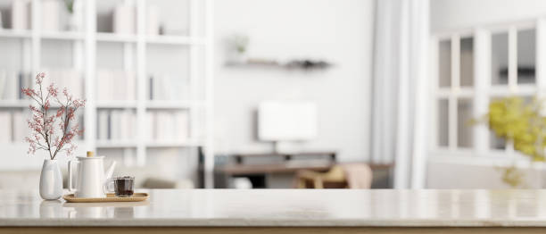 istock Copy space on a tabletop with blurred modern white home office in the background. 1628967507