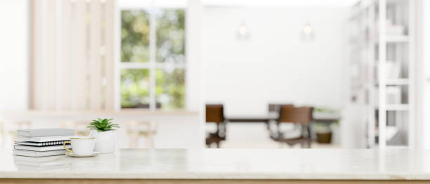 istock Copy space on a tabletop with blurred modern white meeting room in the background 1628967509