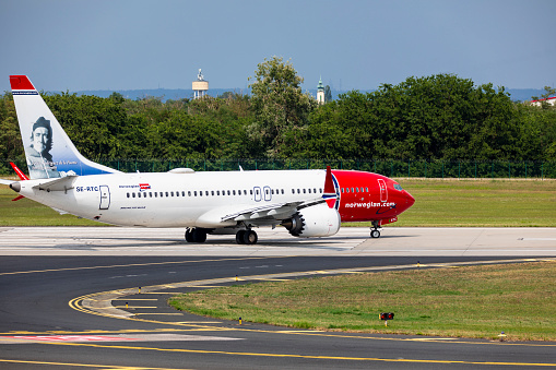 Budapest Hungary Aug. 19, 2023: Norwegian Airline Boeing 737 just taxiing for take off from a busy International airport.