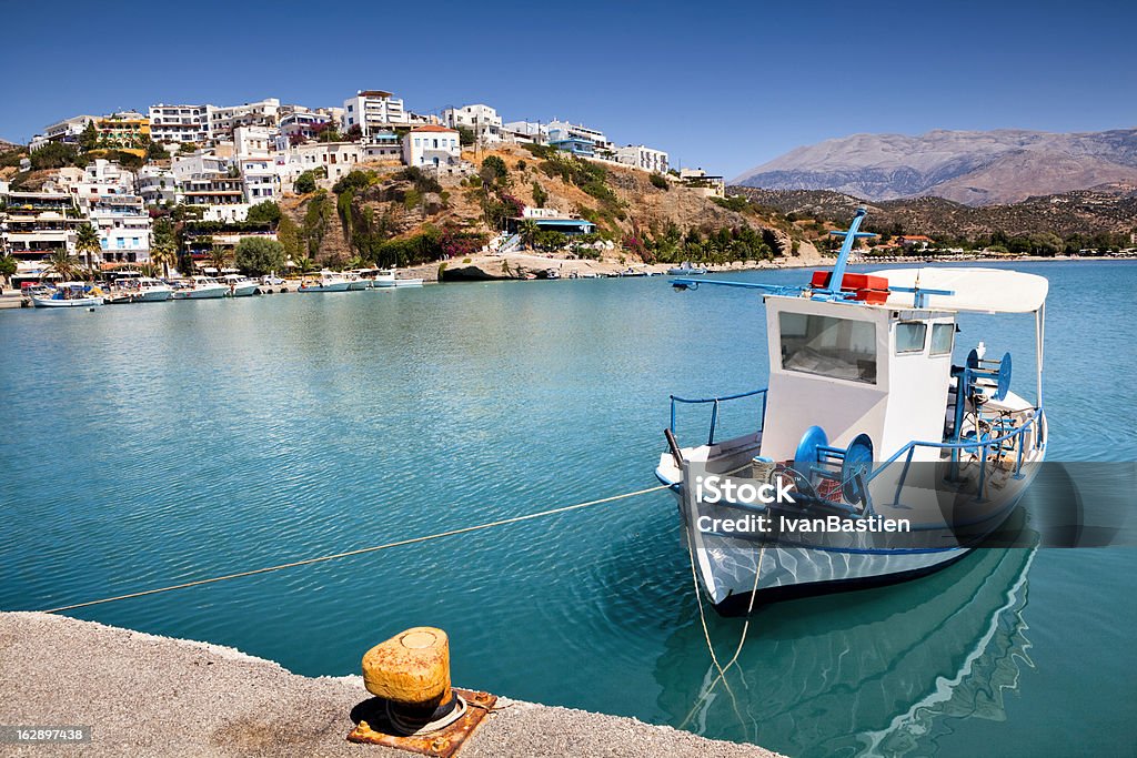 Agia Galini harbour in Crete Agia Galini harbour in Crete Island (Greece) with a moored fishing boat in the foreground. Crete Stock Photo