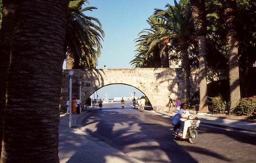 Kos Island, Greece - Aug 1990: view of a stone arch in an avenue of Kos, near the famous plane tree of Hippocrates