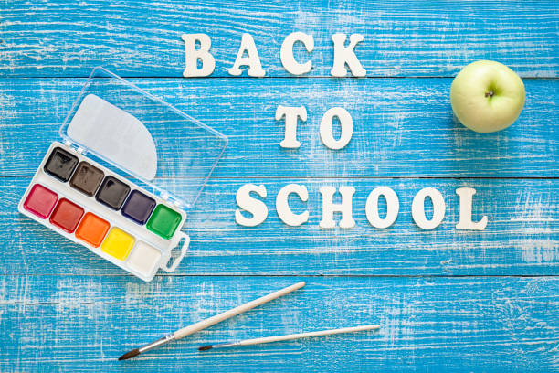 istock Back to school concept on wooden blue background, top view. 1628992131
