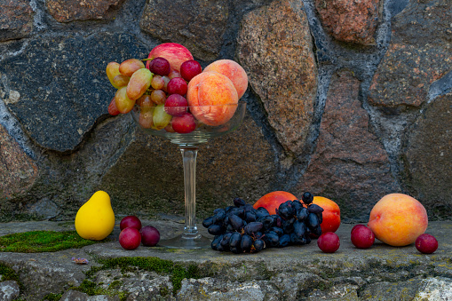 Still life of fruits, rich harvest, peaches and grapes. High quality photo