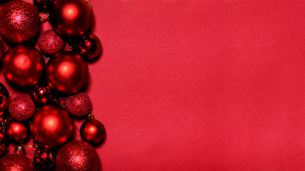 istock Red Christmas and New year background with christmas bauble frame on red paper with copyspace. 1629006650