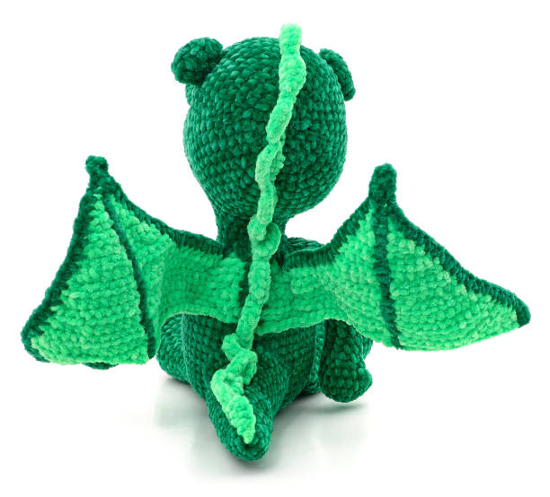 istock Green knitted dragon toy. 1629021616