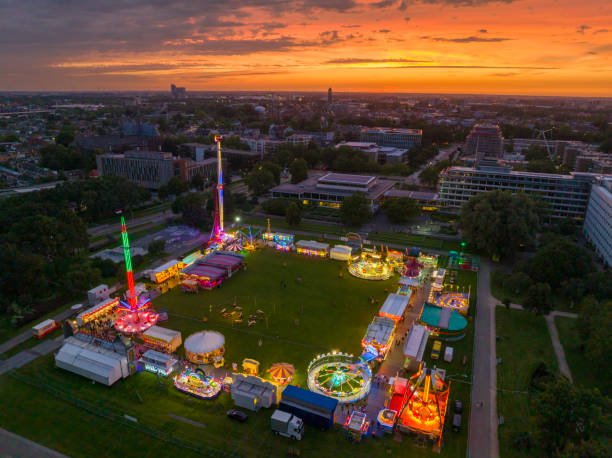 istock Fair during sunset with illuminated fairground attractions seen from above 1629022207