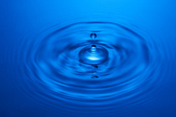 istock Group of water droplets fall and bounce on a water surface 1629026488