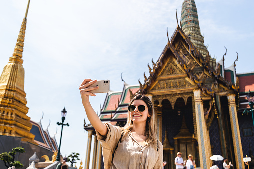 Young woman exploring Grand Palace and Wat Phra Kaew in Bangkok, Thailand