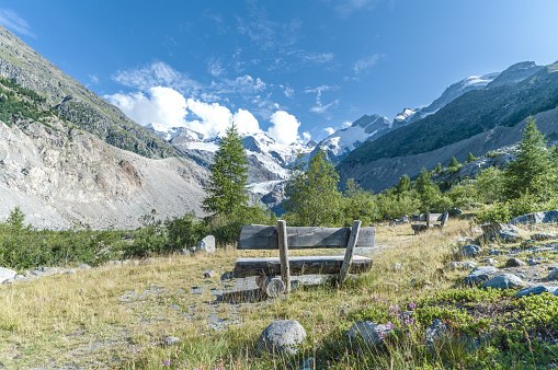 A view from wooden bench on mountain landscape in Swiss alps