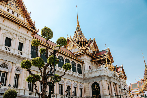 Bangkok, Thailand - April 13, 2022: The Grand Palace, one of the most famous architectural landmarks of the country, has beautiful designs between Thailand's traditional arts and western style.