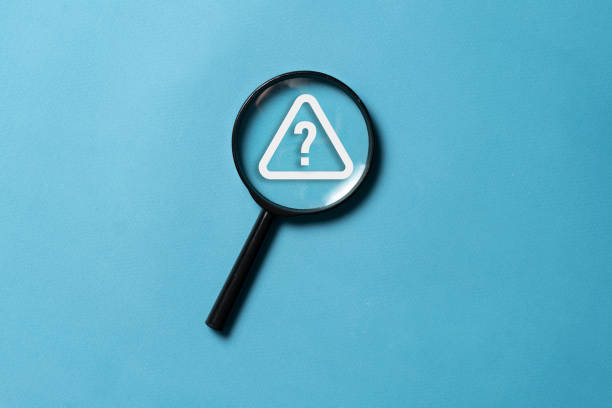 istock top view on a black magnifying glass with a question mark alarm, flat lay 1629045410