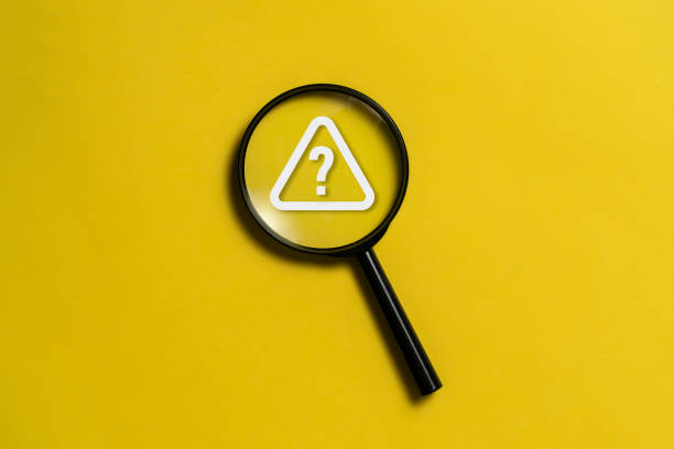 istock top view on a black magnifying glass with a question mark alarm, flat lay 1629045420