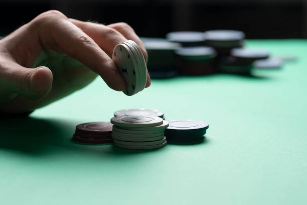 istock poker player holding casino chips in hand, winning the game 1629045938