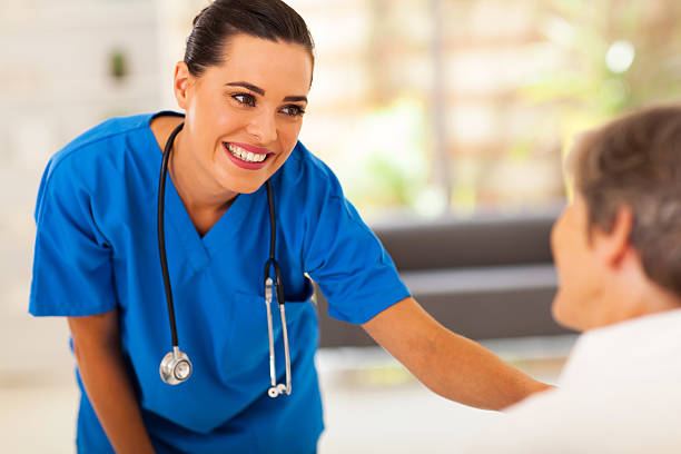 istock friendly young nurse talking to senior patient 162906488