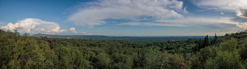 panoramic view of the beautiful green Carso hills at sunset, looking south west towards Trieste during summer season