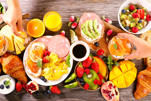 healthy eating- breakfast buffet on the table- fruit, toast, egg, pastry and orange juice