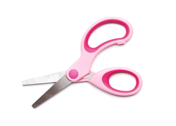 Pink scissors isolated on a white background. School supplies.