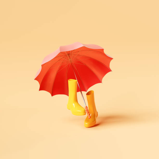 Gumboots under umbrella on yellow background Creative 3D illustration of bright red umbrella placed above walking rubber boots against yellow backdrop levitation stock pictures, royalty-free photos & images