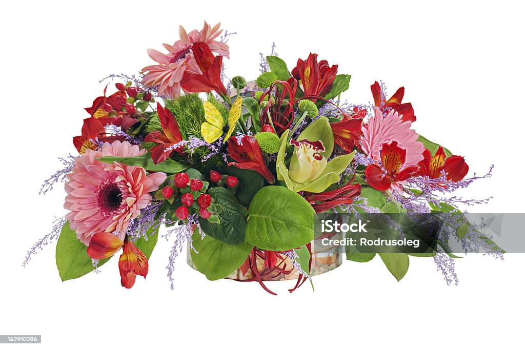Colorful floral arrangement from lilies, cloves and orchids Floral arrangement from lilies, cloves and orchids in cardboard chest on white. Bouquet Stock Photo