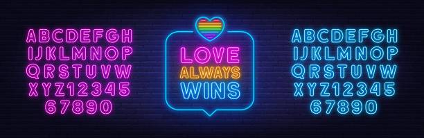 любовь всегда побеждает неоновая вывеска в речевом пузыре на фоне кирпичной стены. - neon light rainbow bright gay pride stock illustrations