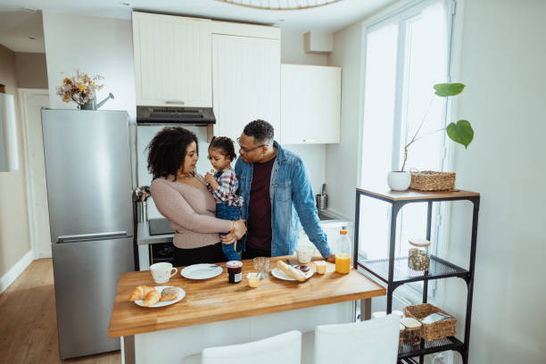 istock Family enjoying breakfast and laughing with daughters 1629111483