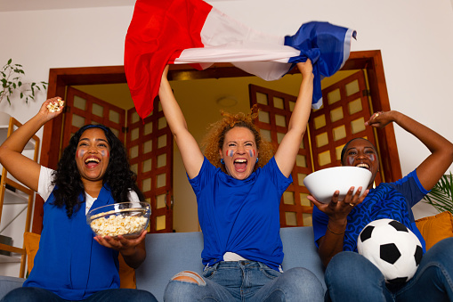 Three young woman France supporters cheering