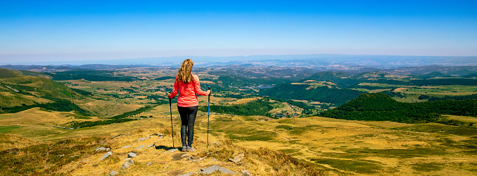 Woman enjoying panoramic view of France ( cantal, auvergne aveyron)