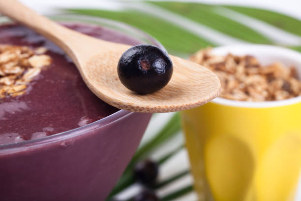 Açai studio shot Studio shot of açai fruit on white background with the natural leaves of palm tree. palm fiber stock pictures, royalty-free photos & images