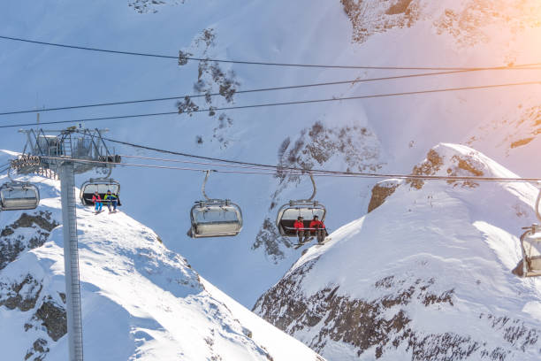 istock Ski resort with an open-type cable car overlooking the snow-covered valleys and the mountain cirque. 1629128237
