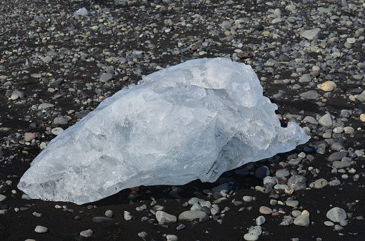 Large chunk of ice on a volcanic black sand beach in Iceland.