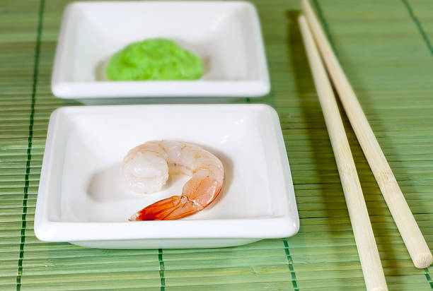 Sushi shrimp and wasabi on bamboo mat