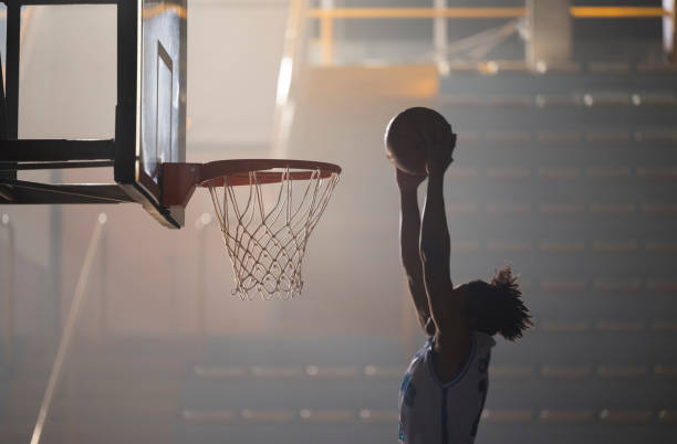 istock Young man throwing basketball to score 1629131220