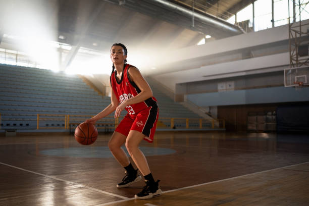 istock Young woman dribbling basketball 1629131241