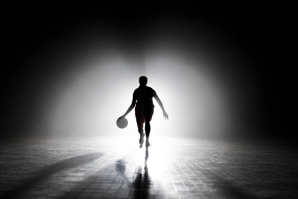 istock Young woman dribbling on court 1629131267