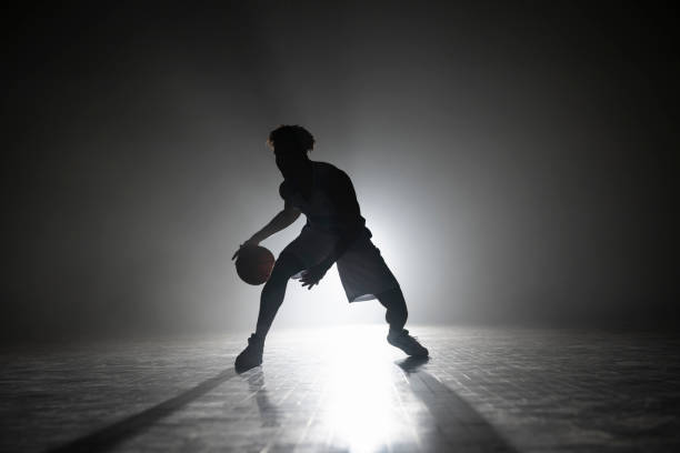 istock Young man dribbling basketball on court 1629131273