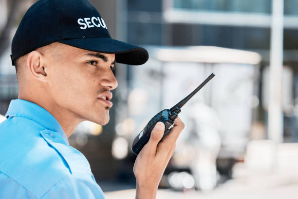 istock Security guard, walkie talkie and man in city in communication, surveillance and thinking. Safety, protection and serious officer on radio to chat on tech in police service, investigation and report 1629137350