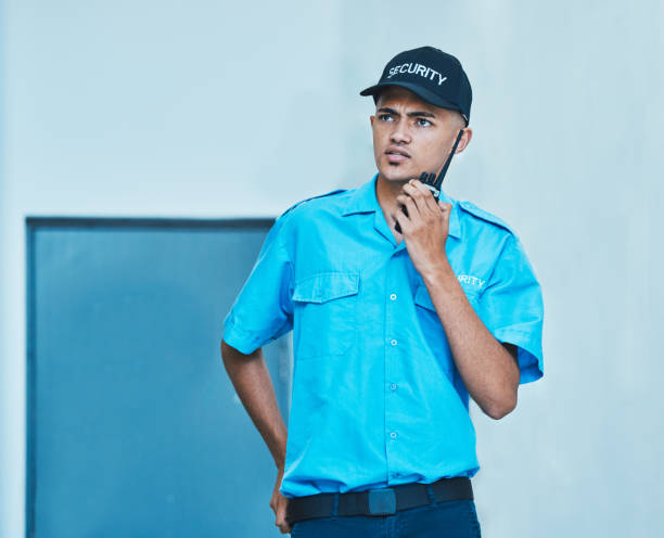 istock Walkie talkie, security guard and man in office in communication, surveillance and thinking. Safety, protection and serious bodyguard on radio to chat on tech in police investigation and inspection 1629137892